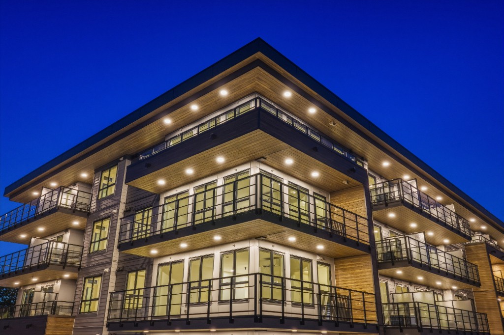 Evening view of City Corners balconies and wood soffits in Surrey