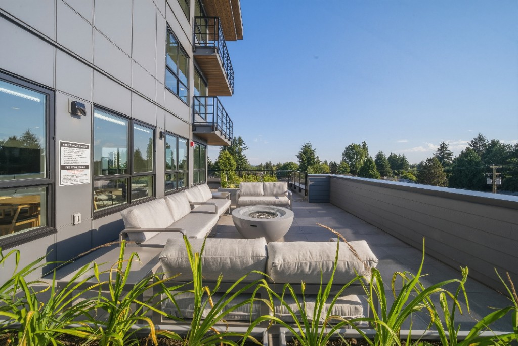 Rooftop lounge with fire pit and seating at City Corners by Zenterra in Surrey