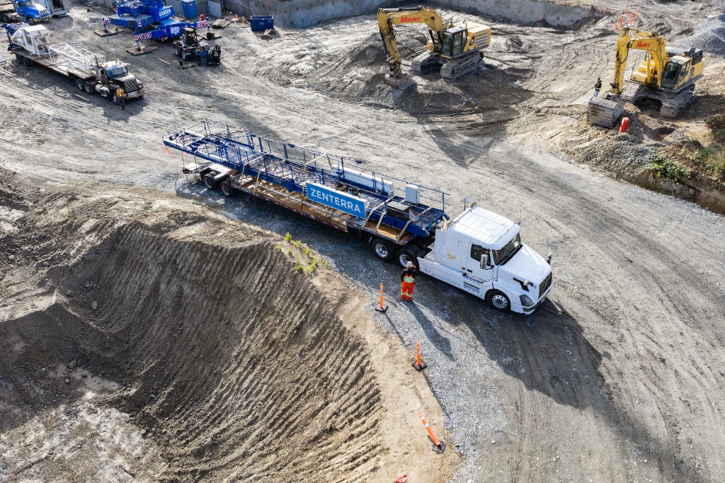 Zenterra flatbed truck on the Clayton Crest construction site in West Clayton, Surrey, delivering crane components