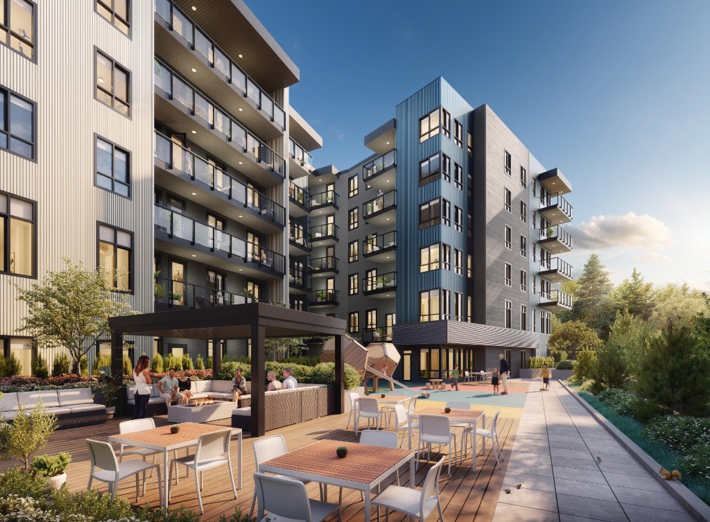 Landscaped courtyard with patio seating and a play area at Clayton Crest, shared by Atlin and Bute in West Clayton, Surrey